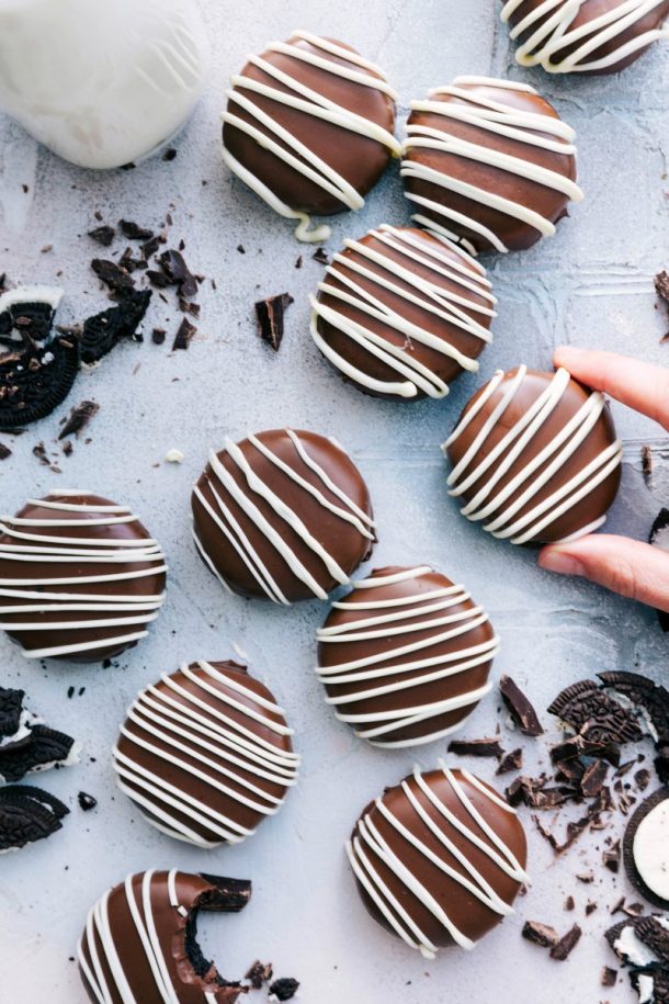 no bake oreo truffle cookies coated in chocolate with white chocolate drizzle