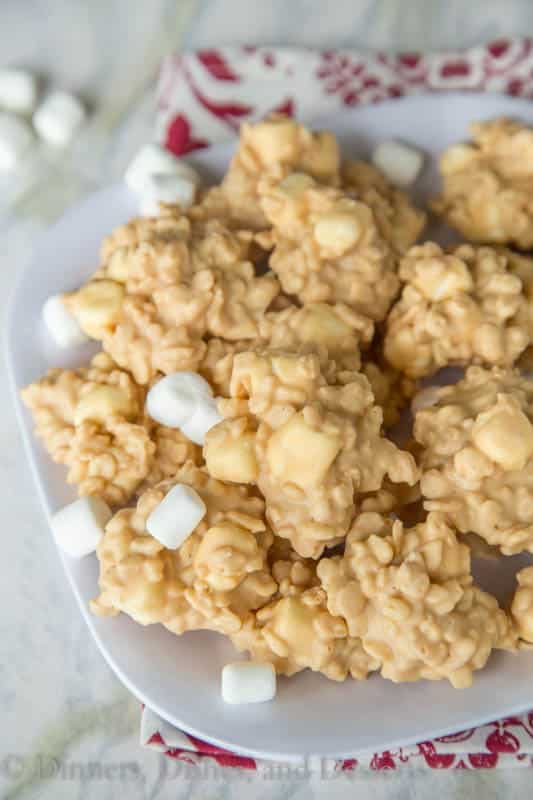 no bake avalanche cookies stacked on white plate with mini marshmallows around