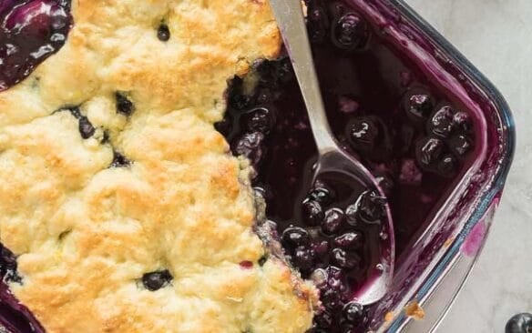 blueberry cobbler in a glass pan overhead