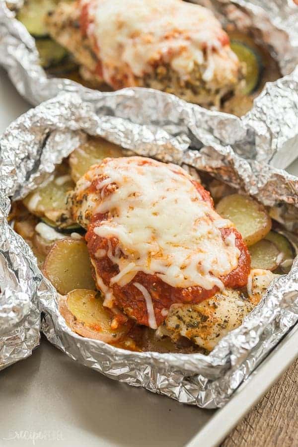 parmesan chicken foil packet close up with tomato sauce and melted cheese