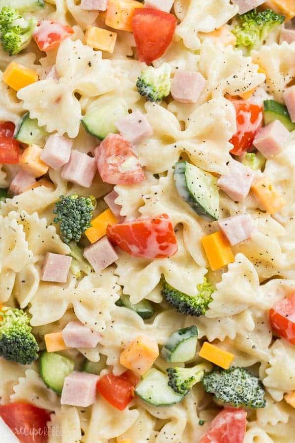 close up image of ranch bowtie pasta salad with ham cheese and vegetables