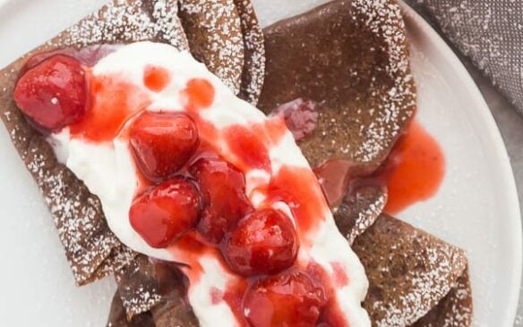 chocolate crepes with whipped cream and strawberry sauce