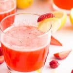 pink lemonade recipe in a glass with strawberry and lemon