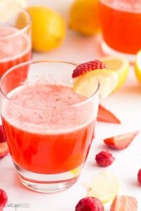 pink lemonade recipe in a glass with strawberry and lemon