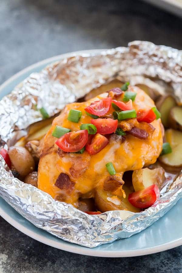 monterey chicken foil packs up close with fresh tomatoes and green onions on top