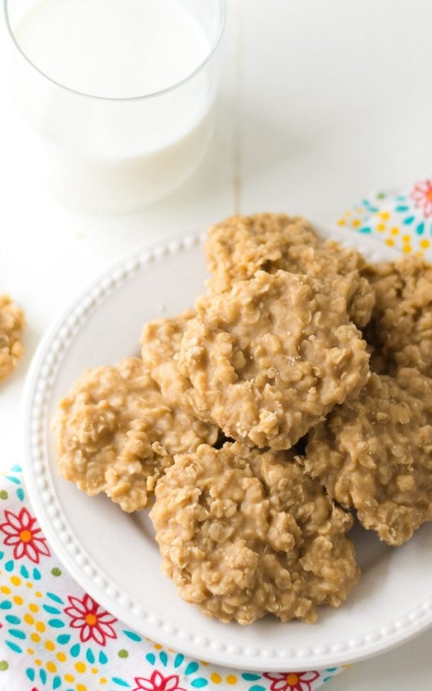 no bake peanut butter cookies on a white plate with a glass of milk