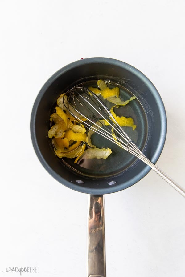 simple syrup with lemon peel strips in pan