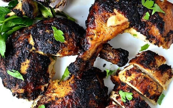 grilled root beer can chicken with parsley and red onions.
