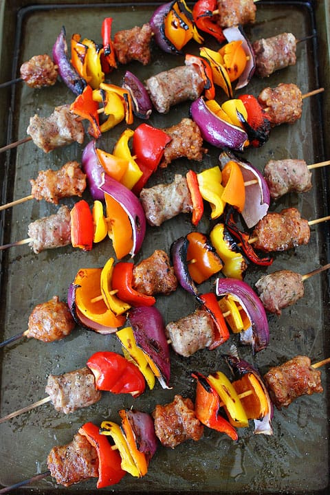 sausage and peppers skewers overhead on sheet pan