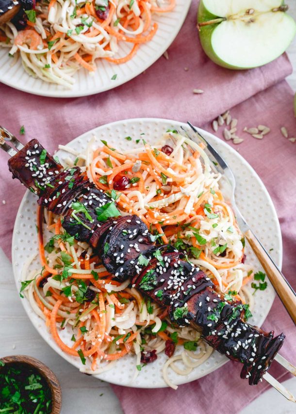 ahi tuna kabobs on white plate over spiralized vegetables