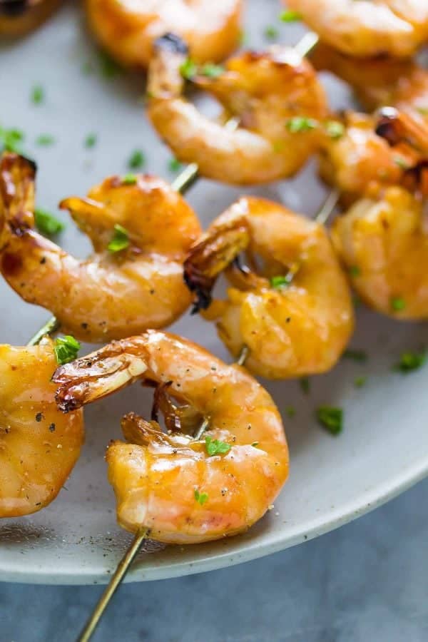 All kinds of kabob recipes for summer grilling! Chicken kabobs, shrimp kabobs, steak kabobs, and dessert kabobs! Because food on a stick is more fun ;) chipotle grilled shrimp skewers close up with chopped parsley