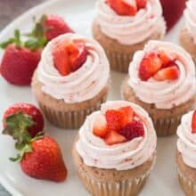strawberry cupcakes with strawberry swiss meringue buttercream on a plate