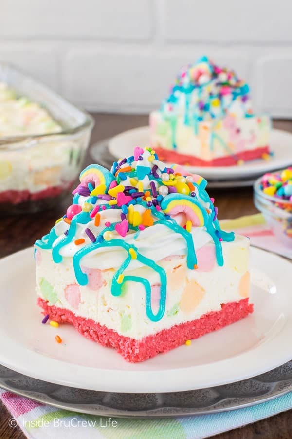 unicorn cheesecake bars with colored marshmallows blue drizzle and lots of sprinkles