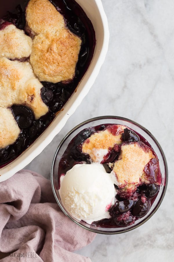 cherry cobbler in a bowl with vanilla ice cream