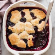 overhead image of cherry cobbler in white baking dish