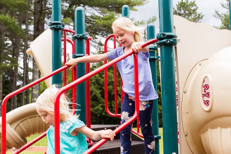 two kids running down the stairs on the playground