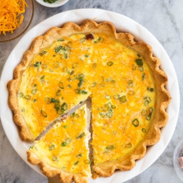 piece of ham quiche being lifted out of whole from above