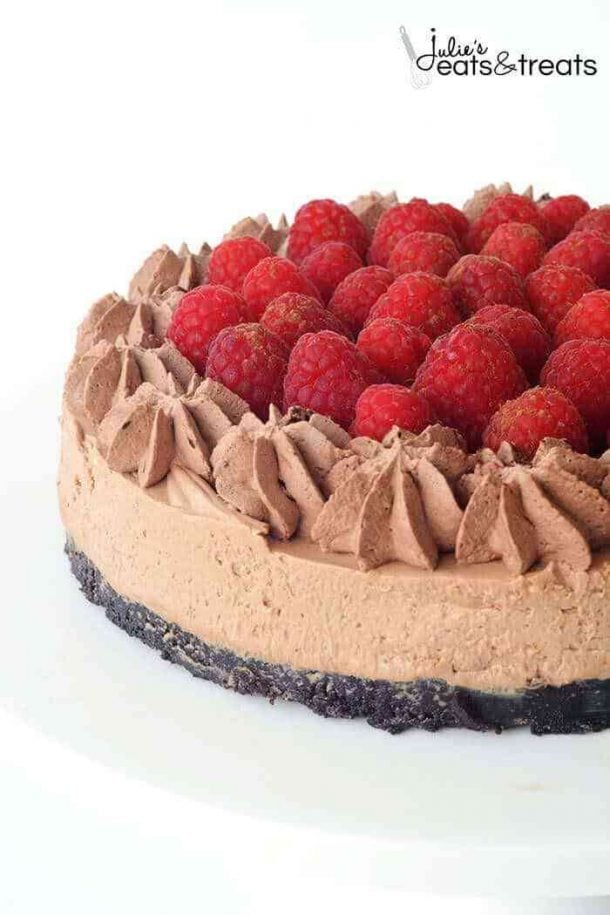 no bake chocolate raspberry cheesecake whole with fresh raspberries on top