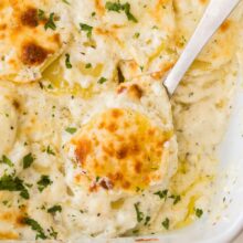 close up image of scalloped potatoes on a serving spoon