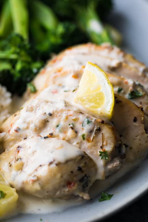 instant pot creamy lemon chicken breasts close up with lemon wedge on top