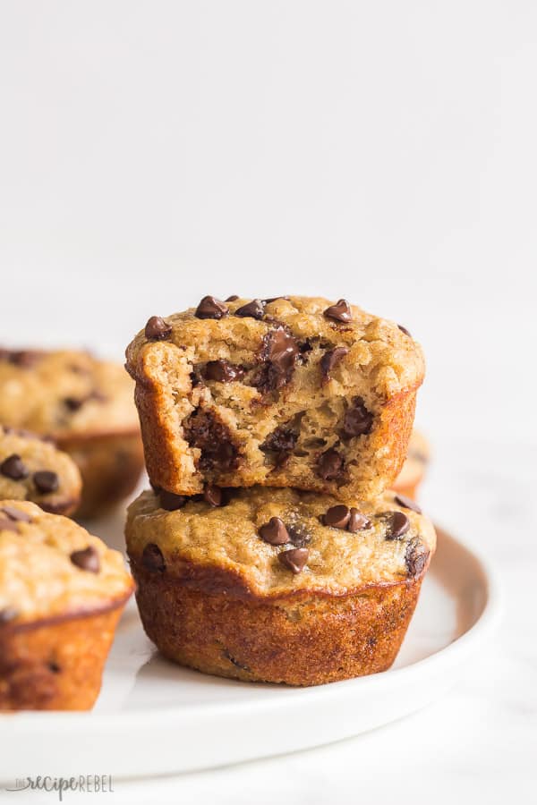 banana oatmeal muffins stack of two with a bite taken out of the top muffin