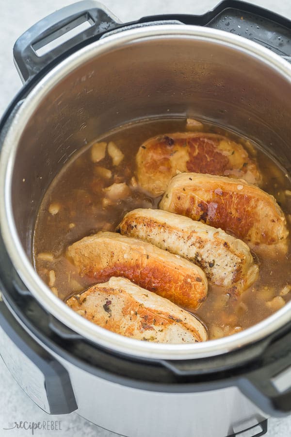 These Instant Pot Pork Chops are so easy and flavorful! Made with a bacon and apple glaze, they are incredibly tender and can be made with boneless or bone in pork chops. #pressurecooker #instantpot #recipe #dinner #pork instant pot pork chops in pressure cooker with bacon apple glaze