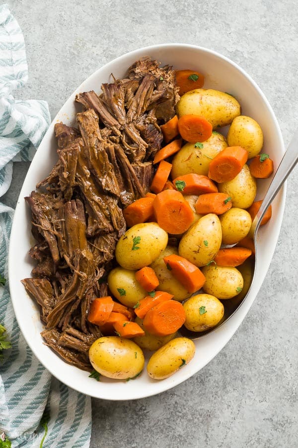 instant pot pot roast overhead on large white platter on grey background