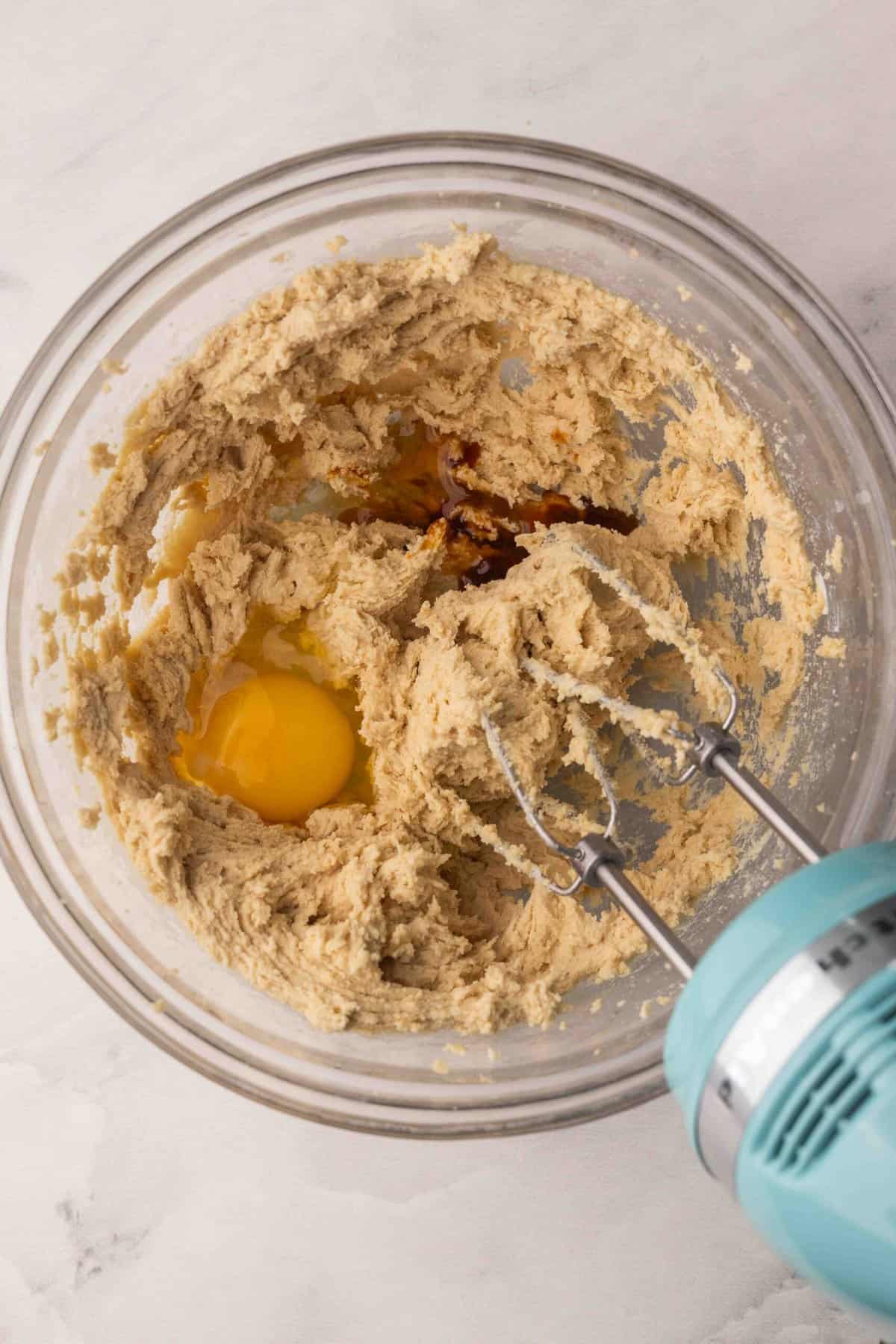egg and vanilla added to bowl of cookie dough.