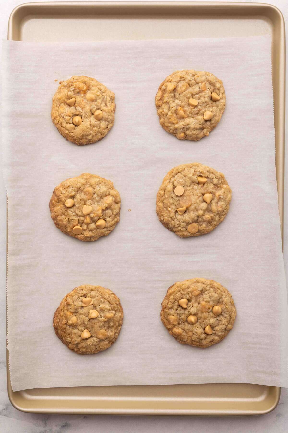 baked oatmeal scotchies on a baking sheet with parchment.