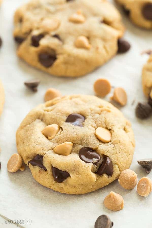 These Peanut Butter Chocolate Chip Cookies are a family favorite! They're soft and chewy and never fluffy! Loaded with chocolate chips and peanut butter chips, they are sure to please the Reese's peanut butter cups lovers in your house! Includes step by step recipe video! #cookies #cookie #peanutbutter #chocolate #baking #dessert peanut butter chocolate chip cookies close up with peanut butter and chocolate chips