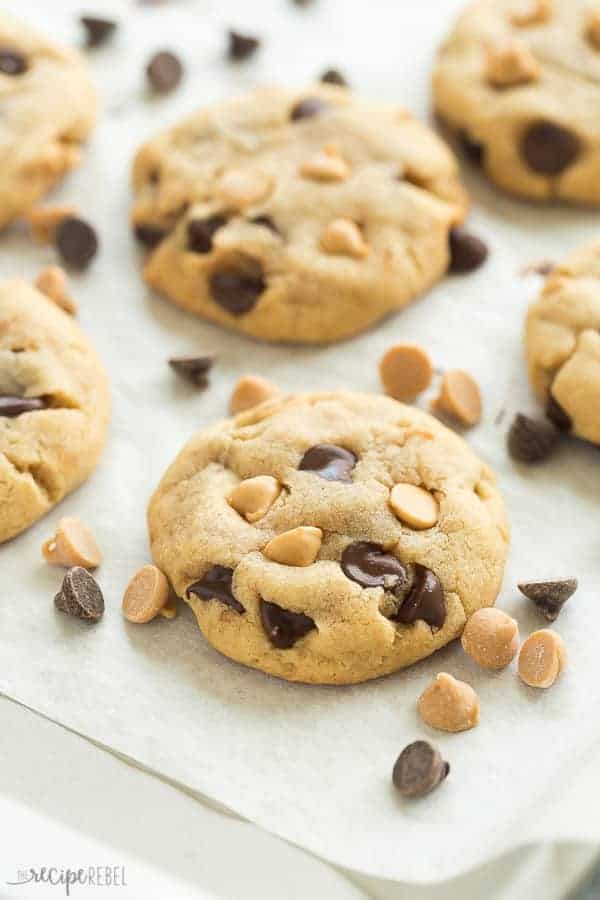 peanut butter chocolate chip cookies on a sheet pan lined with parchment paper