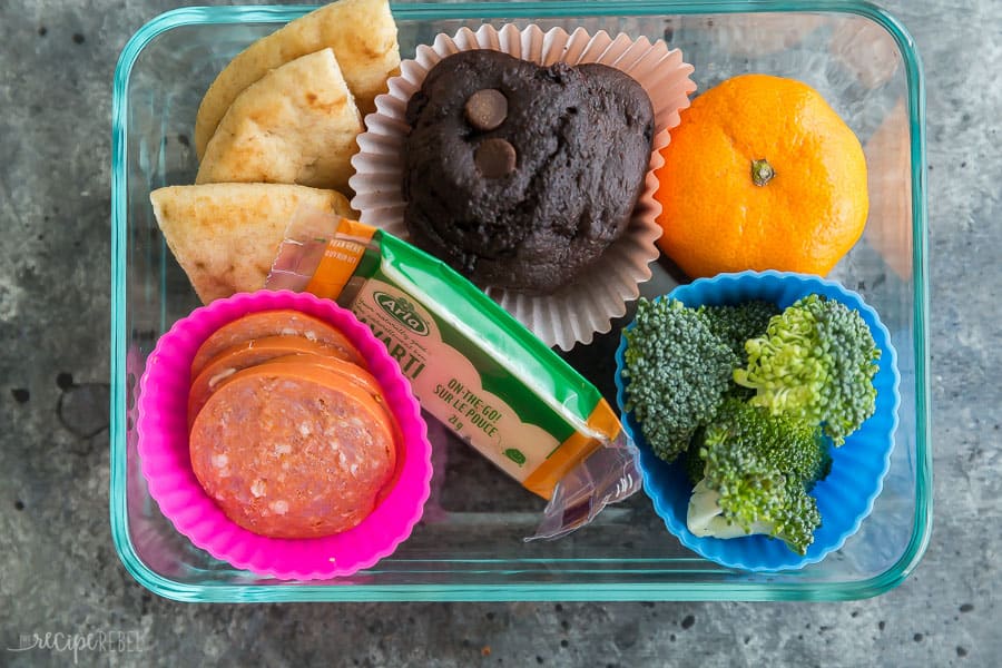school lunch for kids pepperoni and naan with cheese stick and muffin orange and broccoli