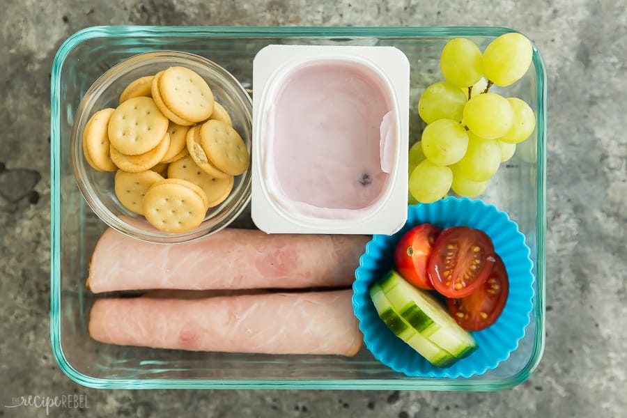 kids lunch ideas ham rolled up with crackers and yogurt cup grapes and cucumbers and tomatoes