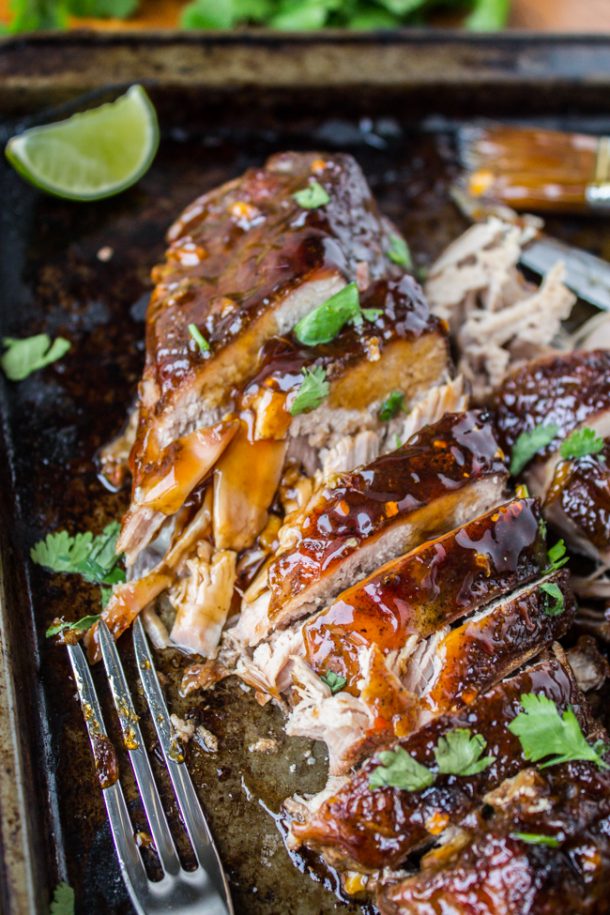 slow cooker pork tenderloin with ginger glaze sliced with fresh parsley on top