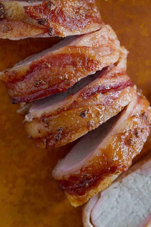 bacon wrapped pork tenderloin overhead sliced very close up