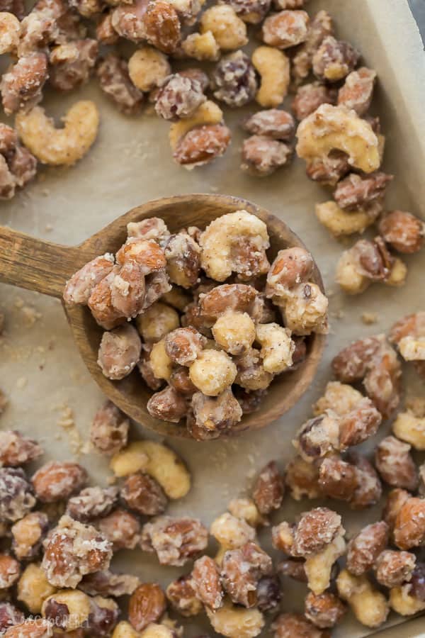 candied nuts overhead close up on wooden spoon on pan