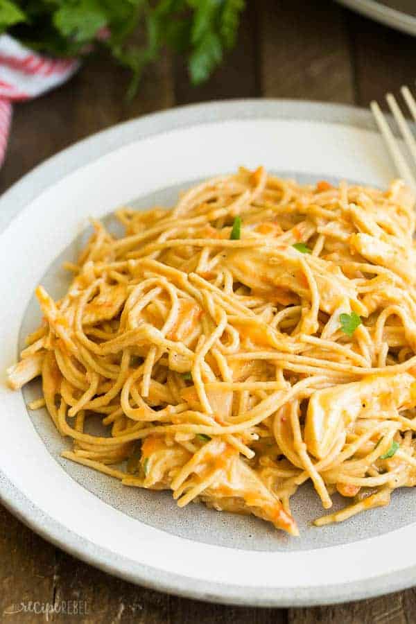 slow cooker chicken spaghetti on a white plate on wooden background
