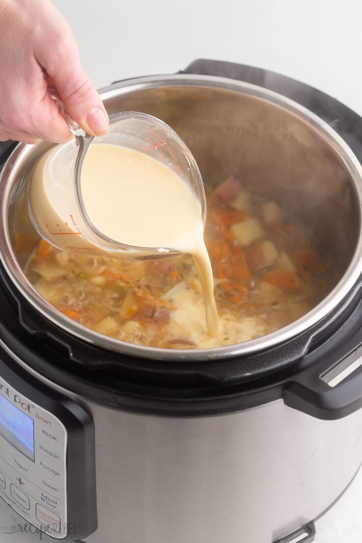 milk being added to soup in pressure cooker.