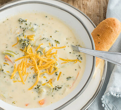 instant pot broccoli cheese soup with shredded cheese on top