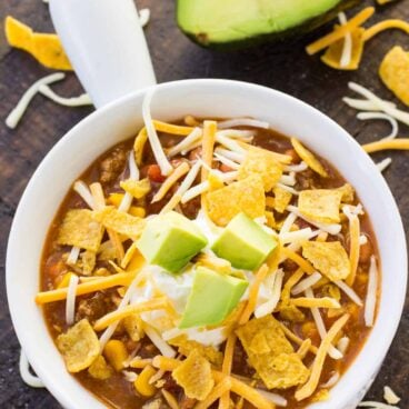 white bowl of instant pot taco soup with cheese on top