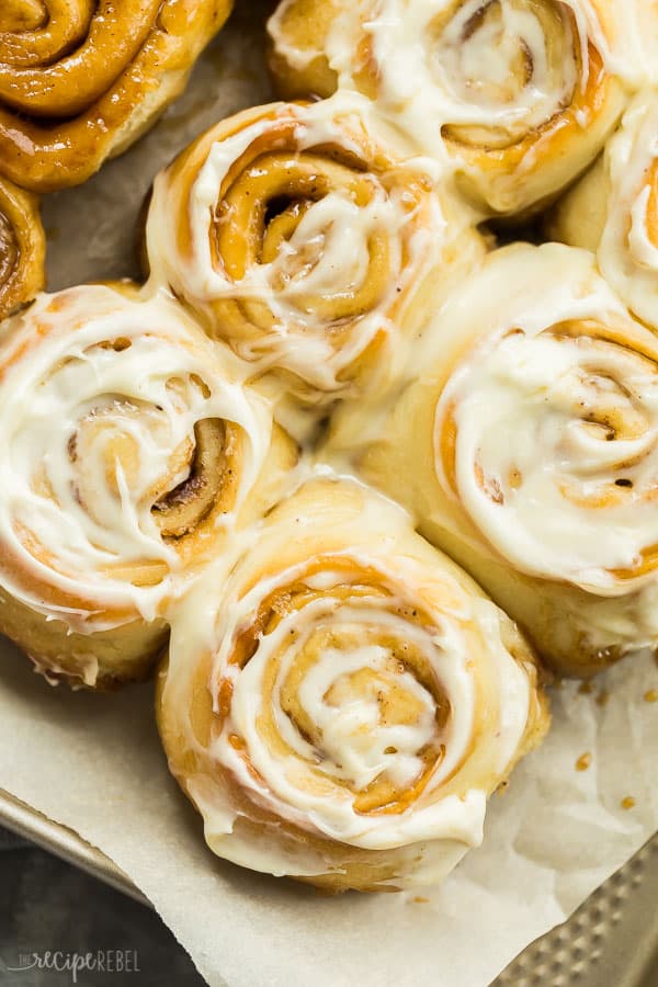 cinnamon buns up close with cream cheese frosting