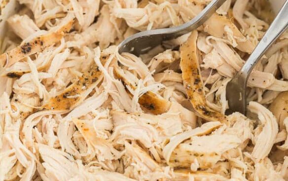 crockpot shredded chicken in white slow cooker