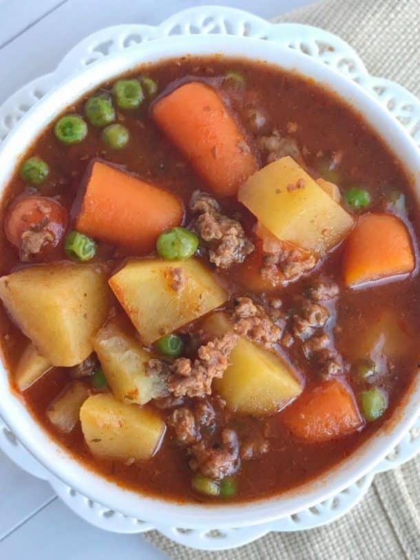 ground beef crock pot stew close up overhead shot in white bowl