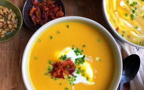 overhead image of bowls of butternut squash apple soup