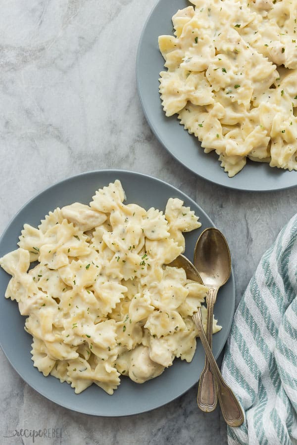 instant pot chicken alfredo pasta overhead on marble on grey plates