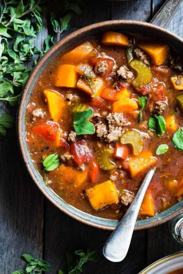 ground beef crock pot hamburger soup close up overhead shot of bowl with spoon stuck into soup