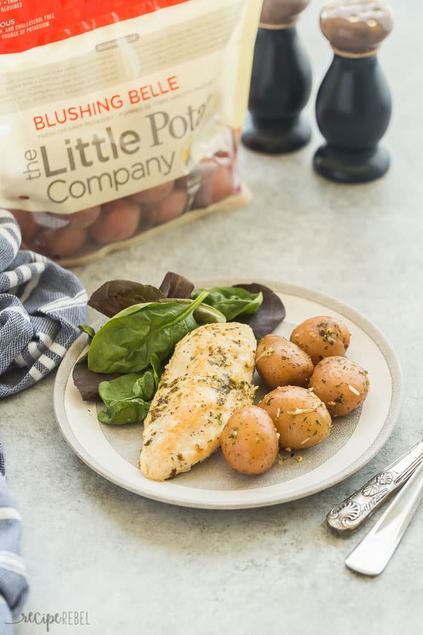 instant pot chicken and potatoes in grey plate on grey background with bag of little potatoes in the background