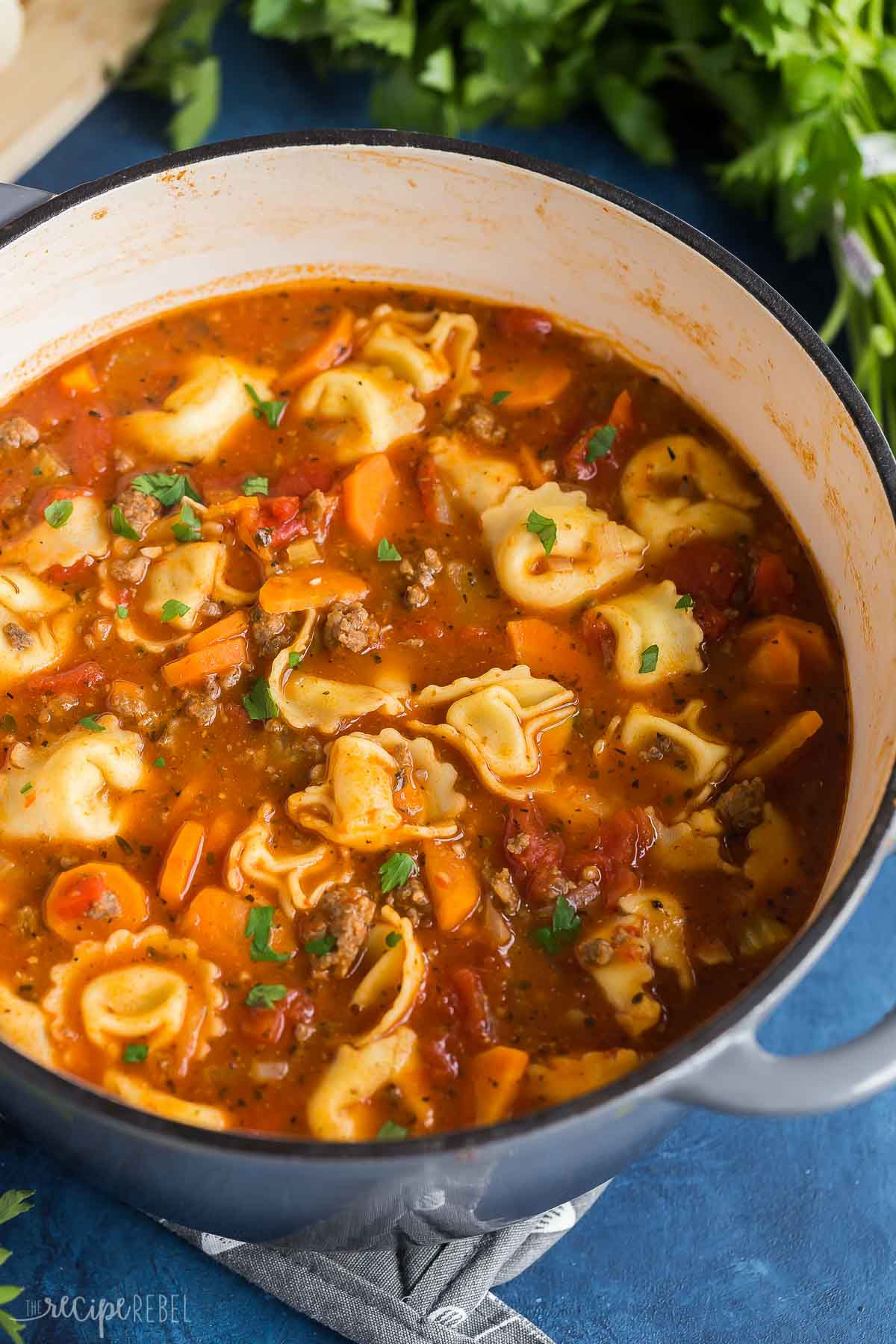 sausage tortellini soup in large grey dutch oven.