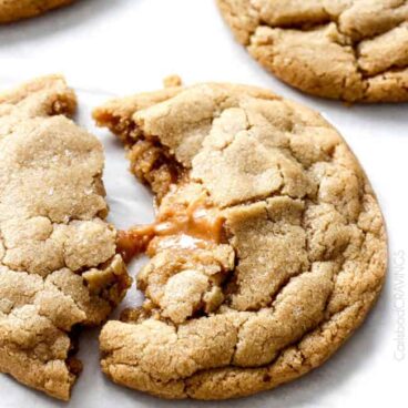 one caramel stuffed cookie broken apart.
