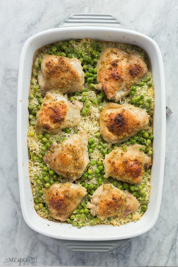 chicken and rice bake overhead in white baking dish on grey marble background